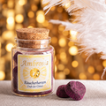 Ambrosia Räucherherzen im Glas vor warmem Lichterhintergrund